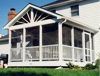 Photo of  a Custom Trex patio deck that includes screened-in gazebo, white railings
and skirt and composite decking