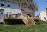 400 Sq. Ft. Saddle Accent TREX decking with a pressure treated railing and a set of 6' steps to ground 