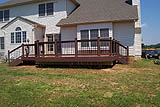 WMoisture Shield terracotta color  with mahogany accents and black Deckorator balusters